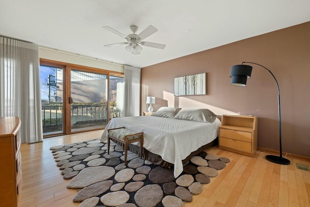 bedroom featuring ceiling fan, light wood-type flooring, and access to outside