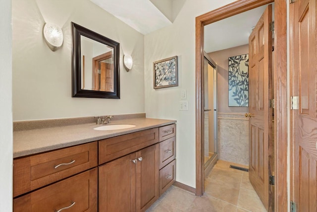 bathroom featuring tile patterned floors, vanity, and a shower with shower door