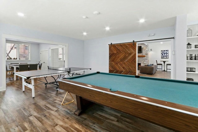 recreation room featuring hardwood / wood-style flooring, a barn door, and billiards