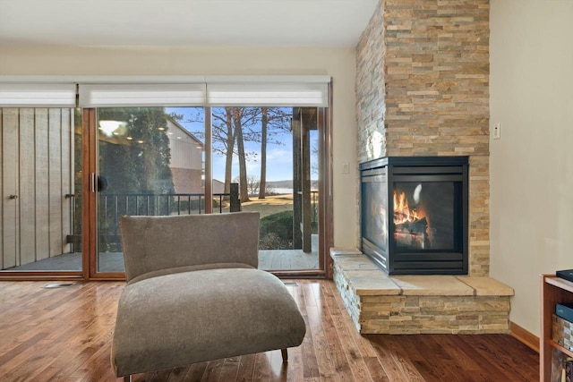 living area featuring hardwood / wood-style flooring and a fireplace