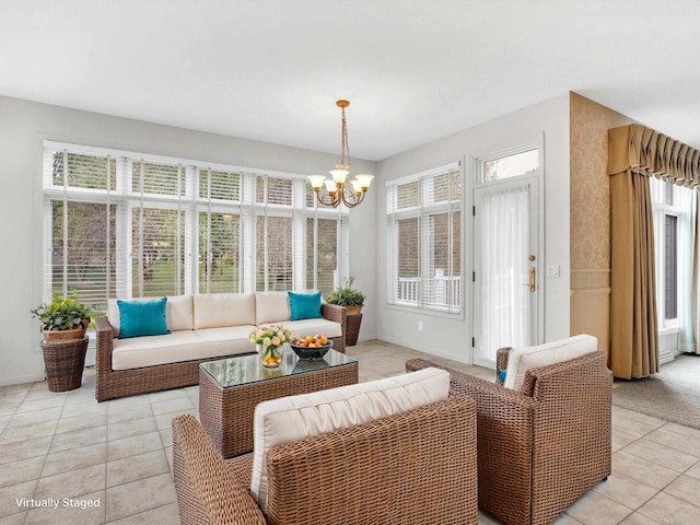 sunroom / solarium with an inviting chandelier