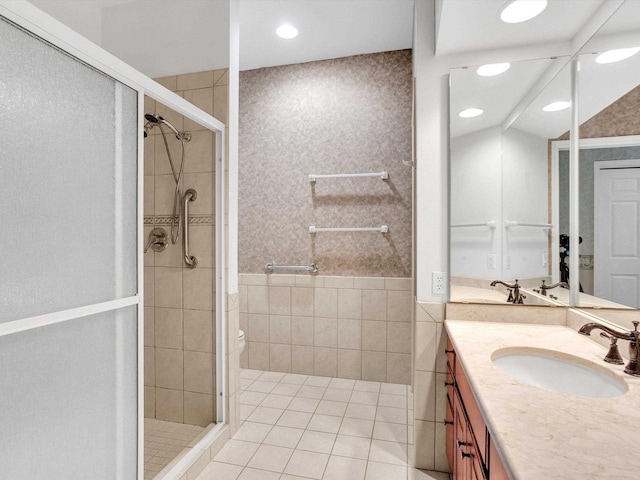 bathroom with tile patterned floors, vanity, toilet, and a shower with shower door