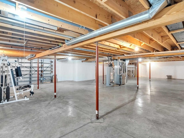 basement featuring gas water heater and heating unit