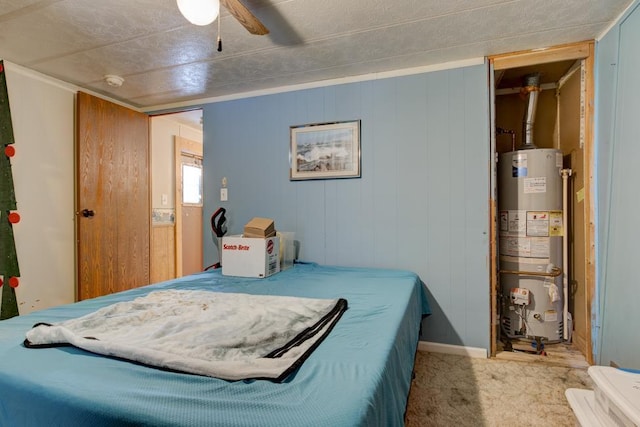 bedroom featuring light carpet, gas water heater, and ceiling fan