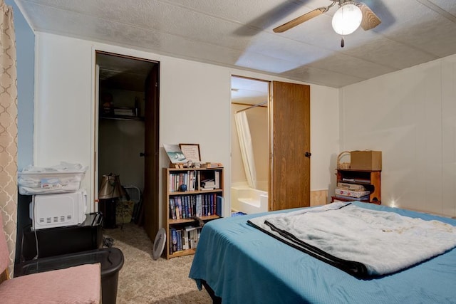 bedroom with a closet, carpet flooring, ceiling fan, and a spacious closet