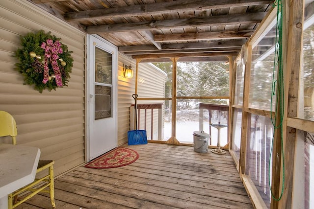 unfurnished sunroom with beam ceiling and wooden ceiling