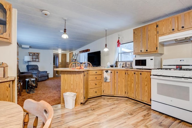 kitchen featuring decorative light fixtures, lofted ceiling, kitchen peninsula, white appliances, and light hardwood / wood-style flooring