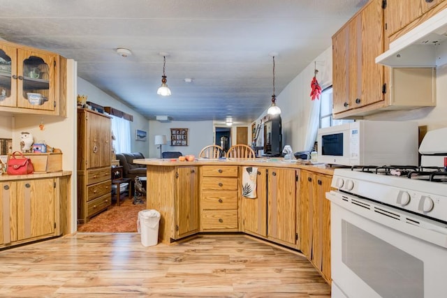 kitchen featuring white appliances, decorative light fixtures, kitchen peninsula, and light hardwood / wood-style floors