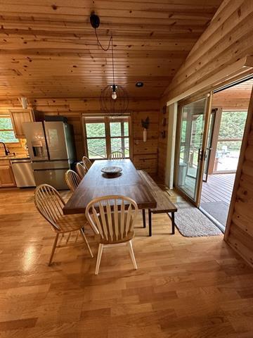 dining area featuring lofted ceiling, wood ceiling, plenty of natural light, and light hardwood / wood-style flooring