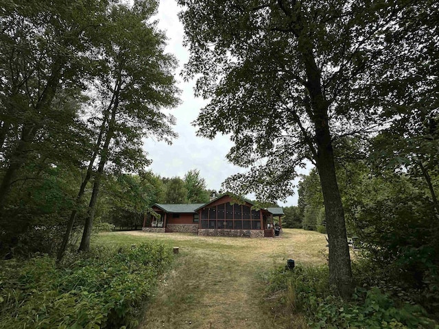 view of yard featuring a sunroom