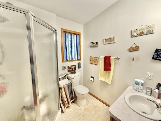 bathroom featuring vanity, toilet, and a shower with shower door