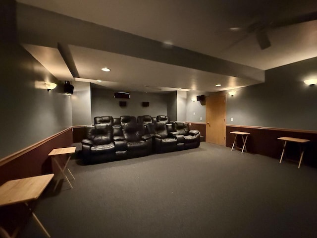 home theater room featuring ceiling fan and carpet