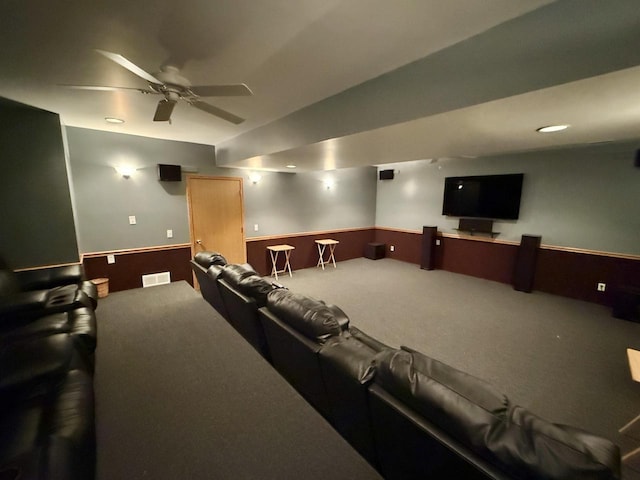 carpeted home theater room featuring ceiling fan