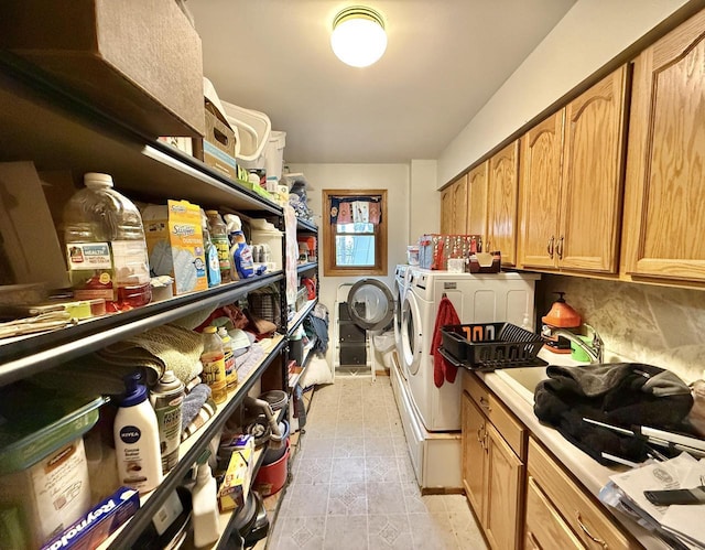 clothes washing area featuring sink and independent washer and dryer