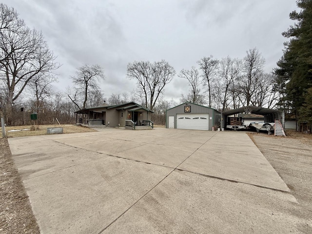 view of side of home featuring an outbuilding, a garage, and a carport