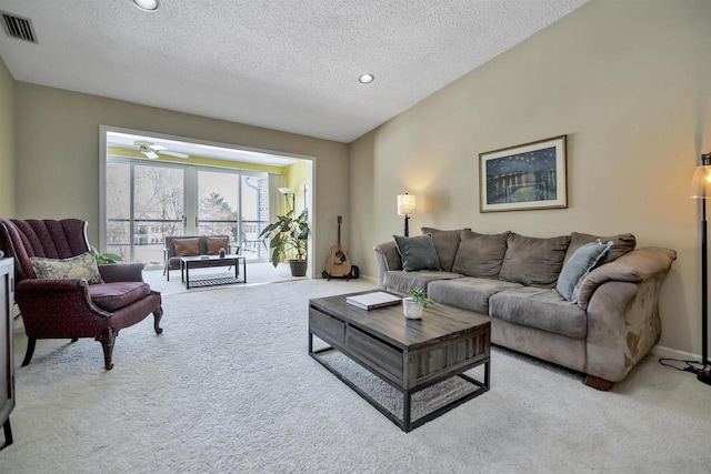 carpeted living room featuring a textured ceiling