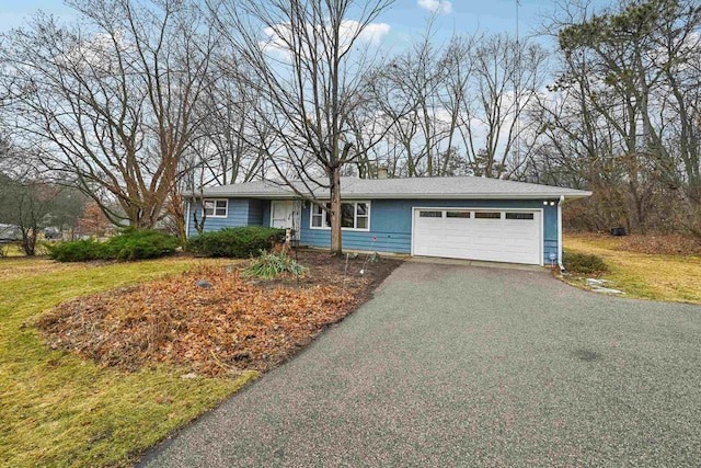 ranch-style home with a garage and a front lawn