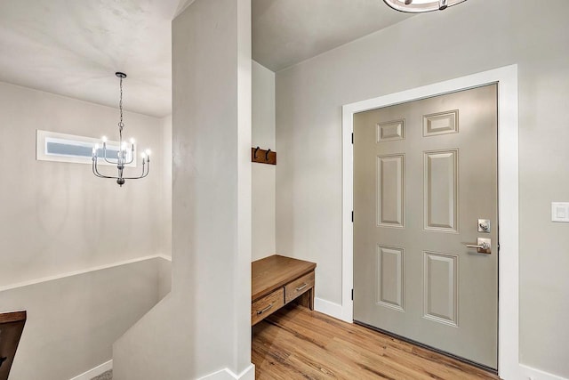 entrance foyer with a notable chandelier and light hardwood / wood-style flooring