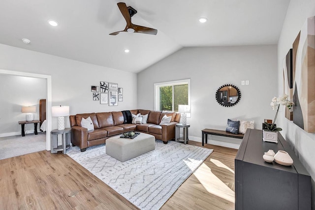 living room with ceiling fan, lofted ceiling, and light hardwood / wood-style floors