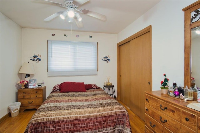 bedroom featuring ceiling fan, light hardwood / wood-style floors, and a closet