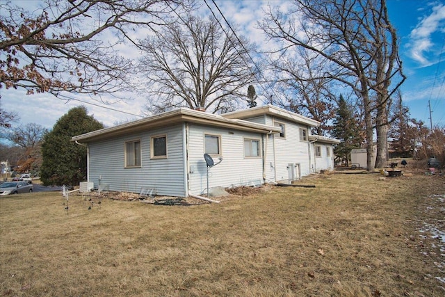 view of property exterior with a yard