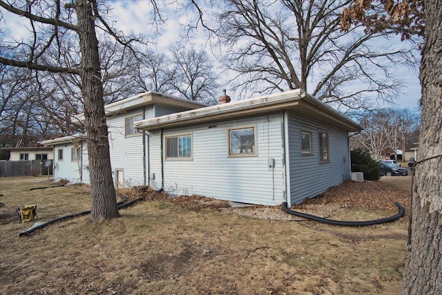 view of side of home with a lawn