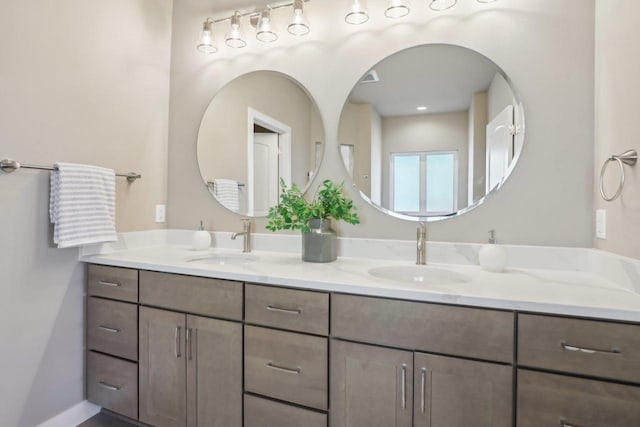 bathroom with a sink and double vanity