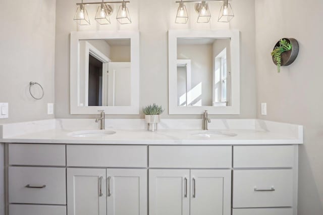 bathroom with a sink and double vanity