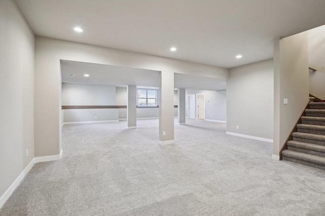 basement featuring stairs, recessed lighting, and baseboards