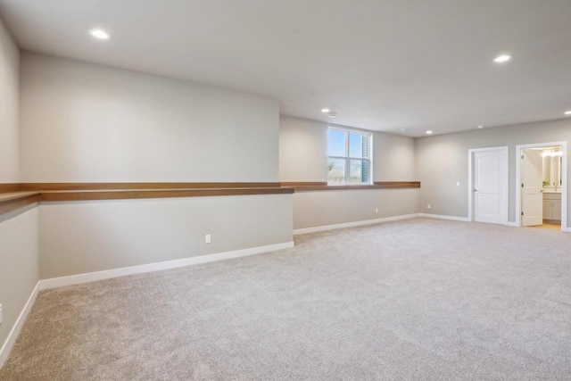 empty room with recessed lighting, baseboards, and light carpet