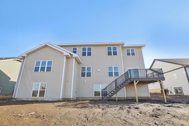 back of property featuring a wooden deck and stairs