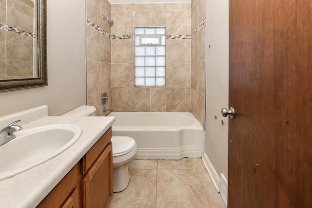 full bathroom with vanity, tile patterned flooring, tiled shower / bath combo, and toilet