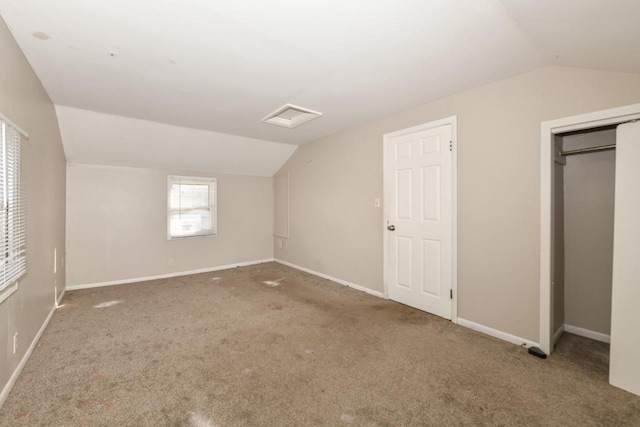 additional living space featuring vaulted ceiling and carpet floors