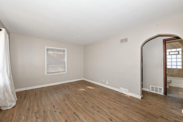 unfurnished room with dark hardwood / wood-style flooring