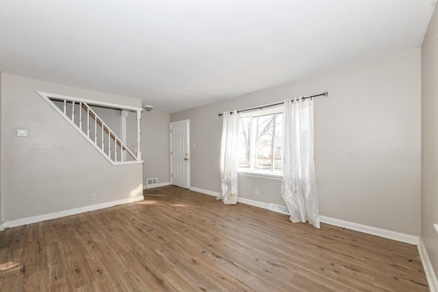 spare room featuring wood-type flooring