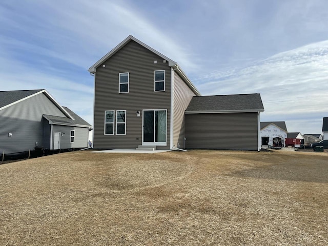 back of house featuring a patio and a lawn