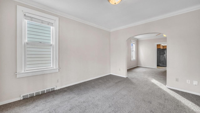 carpeted spare room with crown molding