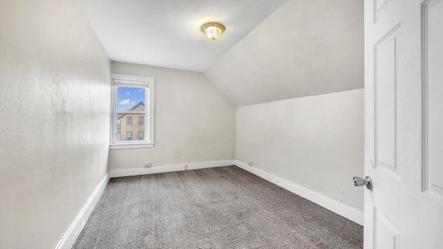 bonus room featuring lofted ceiling and carpet