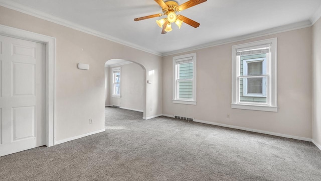 carpeted empty room with crown molding and ceiling fan