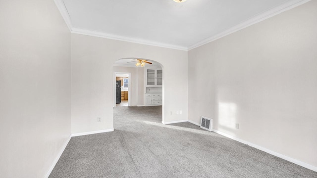 carpeted empty room featuring crown molding and ceiling fan