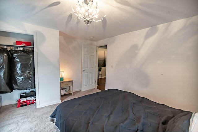 bedroom featuring a chandelier and carpet floors