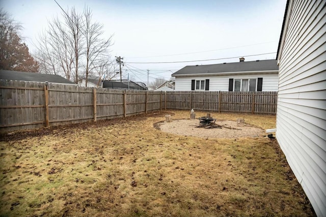 view of yard with an outdoor fire pit