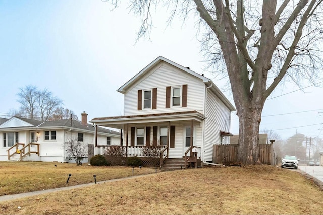 view of front of house featuring a front lawn and covered porch