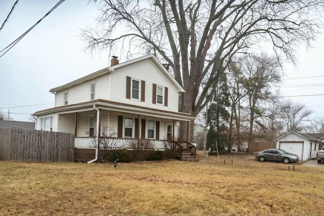 view of front of property featuring a garage, an outdoor structure, covered porch, and a front lawn