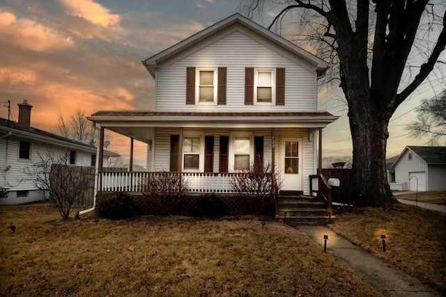 view of front of home with a lawn and covered porch