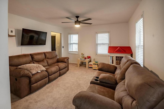 carpeted living room featuring ceiling fan