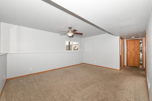 carpeted empty room featuring ceiling fan