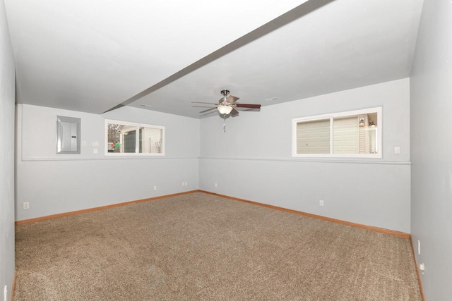 carpeted spare room featuring electric panel and ceiling fan