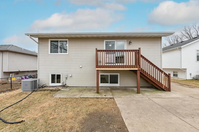 back of house featuring a yard, central AC, and a patio