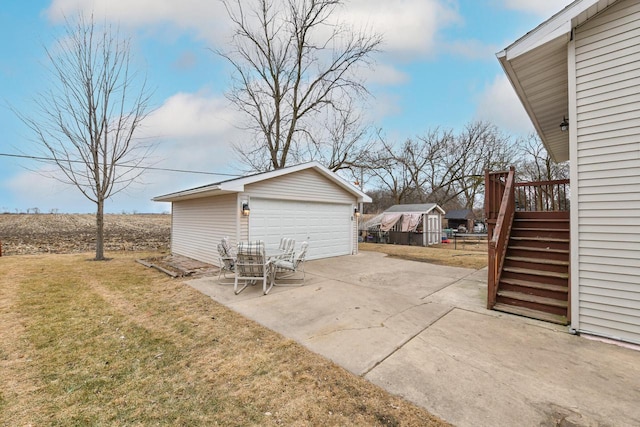 view of patio / terrace with an outbuilding and a garage